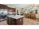 Open concept kitchen with a center island, stainless steel appliances and dark cabinetry at 41011 W Walker Way, Maricopa, AZ 85138