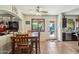 Open-concept kitchen and dining area with tile floors and backyard views at 41011 W Walker Way, Maricopa, AZ 85138