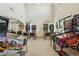 Spacious living room with high ceilings and an array of pinball machines at 41011 W Walker Way, Maricopa, AZ 85138