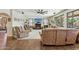 Bright living room with a ceiling fan, neutral colored furniture and a cozy fireplace at 41011 W Walker Way, Maricopa, AZ 85138