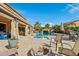 This backyard features a pristine pool, jacuzzi, rock waterfall, covered patio, and desert landscaping at 41011 W Walker Way, Maricopa, AZ 85138