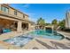 An inviting pool features a waterfall, spa, and covered patio for relaxing and enjoying the outdoors at 41011 W Walker Way, Maricopa, AZ 85138