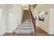 Carpeted staircase with decorative railing and a view of the upper-level decor at 41011 W Walker Way, Maricopa, AZ 85138