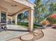 Covered back patio overlooking a well-maintained lawn and lush landscaping at 4215 W Reddie Loop, Phoenix, AZ 85083