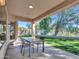 Relaxing back patio featuring a dining set and a view of the landscaped backyard at 4215 W Reddie Loop, Phoenix, AZ 85083