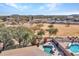 Scenic backyard oasis with a sparkling pool, lush landscaping, and mountain views beyond the property line at 4215 W Reddie Loop, Phoenix, AZ 85083