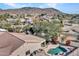 Inviting backyard featuring a private pool, desert landscaping, a covered patio, and a mountain view at 4215 W Reddie Loop, Phoenix, AZ 85083