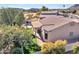 Back of home featuring a pool, desert landscaping, a covered patio with outdoor dining, and lush green grass at 4215 W Reddie Loop, Phoenix, AZ 85083
