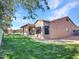 Expansive backyard with lush green lawn and covered patio at 4215 W Reddie Loop, Phoenix, AZ 85083