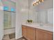 Bathroom with a vanity, large mirror, and a shower/tub combination with a sliding glass door at 4215 W Reddie Loop, Phoenix, AZ 85083