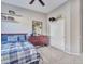 Bedroom featuring a large window, ceiling fan, carpet, and a dresser with decorations at 4215 W Reddie Loop, Phoenix, AZ 85083