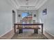 Spacious dining room with large windows and a rustic wood dining table with bench at 4215 W Reddie Loop, Phoenix, AZ 85083