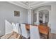 Elegant dining room featuring a wood table, white chairs, and arched doorways at 4215 W Reddie Loop, Phoenix, AZ 85083