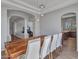 Open dining area with wood table, white chairs, and views into other living spaces at 4215 W Reddie Loop, Phoenix, AZ 85083
