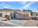 Exterior of home with a three-car garage, desert landscaping, and a red tile roof at 4215 W Reddie Loop, Phoenix, AZ 85083