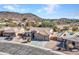 Aerial view of home with a tile roof, three-car garage, desert landscaping, pool, and mountain views at 4215 W Reddie Loop, Phoenix, AZ 85083