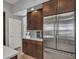 Modern kitchen features stainless steel appliances, rich wood cabinetry, and stylish backsplash at 4215 W Reddie Loop, Phoenix, AZ 85083