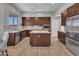 Modern kitchen features stainless steel appliances, a spacious island, and sleek cabinetry at 4215 W Reddie Loop, Phoenix, AZ 85083