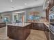 Open kitchen with stainless appliances, center island, and seamless access to living areas at 4215 W Reddie Loop, Phoenix, AZ 85083