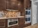 Close up on modern stainless appliances and striking backsplash at 4215 W Reddie Loop, Phoenix, AZ 85083