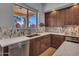 Modern kitchen boasts quartz counters, stainless appliances, and backyard views at 4215 W Reddie Loop, Phoenix, AZ 85083