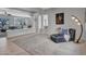 Open-concept living room featuring elegant columns, plush carpet, and a comfortable seating area at 4215 W Reddie Loop, Phoenix, AZ 85083