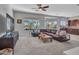 Spacious living room features a comfortable leather sofa, ceiling fan, and abundant natural light at 4215 W Reddie Loop, Phoenix, AZ 85083