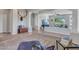 Spacious living room with decorative columns, hardwood floors, and a cozy lounge area with natural light at 4215 W Reddie Loop, Phoenix, AZ 85083