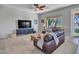 Bright living room with a large window, a modern entertainment center, and inviting seating area at 4215 W Reddie Loop, Phoenix, AZ 85083