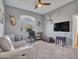 Office features a desk in front of a window, leather chair, and television on the wall at 4215 W Reddie Loop, Phoenix, AZ 85083