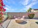 Cozy patio with a charming fire pit and seating, perfect for outdoor relaxation at 4215 W Reddie Loop, Phoenix, AZ 85083