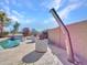 Stunning backyard featuring a pool, outdoor shower, and lush landscaping at 4215 W Reddie Loop, Phoenix, AZ 85083