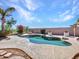 Backyard pool with stone features, landscaping, and a cozy fire pit area at 4215 W Reddie Loop, Phoenix, AZ 85083