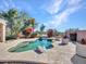 Inviting backyard pool area surrounded by lush landscaping and decorative rocks at 4215 W Reddie Loop, Phoenix, AZ 85083