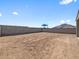 Backyard with block wall and mountains in the background. The backyard is ready for landscaping at 4351 W Jeanette Ln, San Tan Valley, AZ 85144