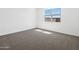 Bright bedroom with gray carpet, white walls, and a window at 4351 W Jeanette Ln, San Tan Valley, AZ 85144