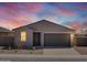 Charming single-story home featuring a gray exterior, landscaped front yard, and a two-car garage at 4351 W Jeanette Ln, San Tan Valley, AZ 85144