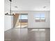 Well-lit living room featuring tile floors, a chandelier, and sliding glass doors to the backyard at 4351 W Jeanette Ln, San Tan Valley, AZ 85144