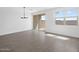 Well-lit living room featuring tile floors, a chandelier, and sliding glass doors to the backyard at 4351 W Jeanette Ln, San Tan Valley, AZ 85144