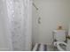 Clean bathroom featuring a shower with curtain and accessibility hand rail at 4434 W Dahlia Dr, Glendale, AZ 85304