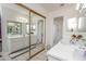 Bright bathroom featuring double sink vanity, large mirrors, and a separate shower area at 4434 W Dahlia Dr, Glendale, AZ 85304