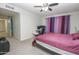 Spacious bedroom with plush carpeting, ceiling fan, and ensuite bathroom with a dedicated desk space at 4434 W Dahlia Dr, Glendale, AZ 85304