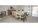 Dining area with a large table, stylish chairs, fireplace, and sliding glass doors to the pool at 4434 W Dahlia Dr, Glendale, AZ 85304