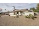 Inviting single-level house featuring desert landscaping, a two-car garage, and a cozy front porch at 4434 W Dahlia Dr, Glendale, AZ 85304