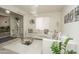 Bright living room featuring a plush white sofa, glass coffee table, and modern decor at 4434 W Dahlia Dr, Glendale, AZ 85304