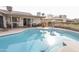 Private backyard oasis with a sparkling pool, comfortable seating, and outdoor dining area at 4434 W Dahlia Dr, Glendale, AZ 85304