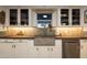 Close up view of the kitchen featuring a concrete farmhouse sink, tiled backsplash, and stainless steel dishwasher at 45 W Edgemont Ave, Phoenix, AZ 85003