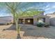 A view of the backyard featuring desert landscaping, a covered patio, and unique desert trees at 4624 W Heyerdahl Ct, New River, AZ 85087