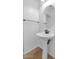 Powder room featuring a pedestal sink, oval mirror, and tile flooring at 4624 W Heyerdahl Ct, New River, AZ 85087