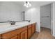 Bathroom featuring double sinks, a large mirror, and neutral tiling at 4624 W Heyerdahl Ct, New River, AZ 85087